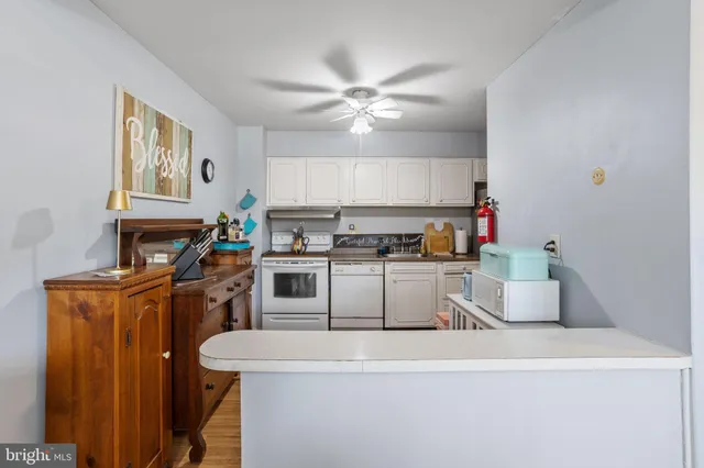 a kitchen with a refrigerator and a stove top oven