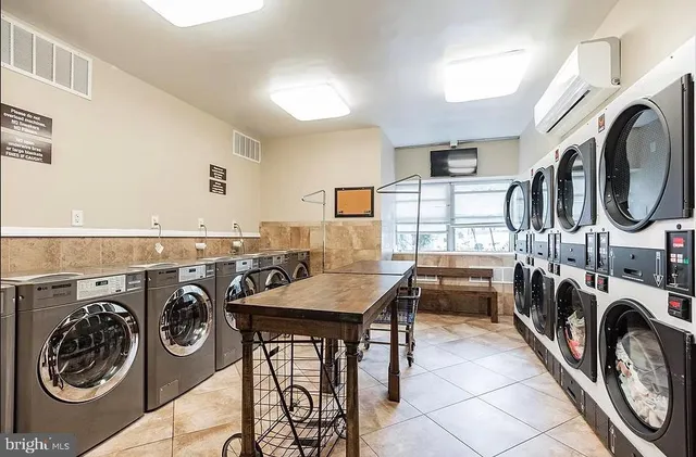 a view of a storage and utility room with washer and dryer