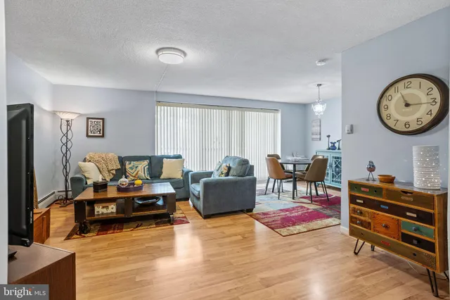 a living room with furniture gym equipment and a large window