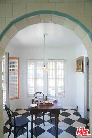 a kitchen with granite countertop white cabinets and window