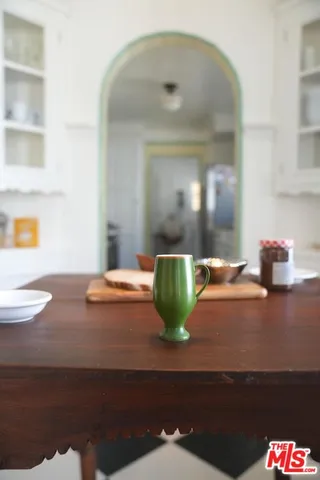 a view of a dining room with furniture and a potted plant