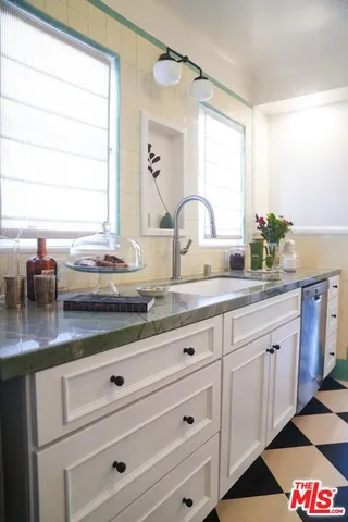 a kitchen with stainless steel appliances granite countertop a sink stove and cabinets