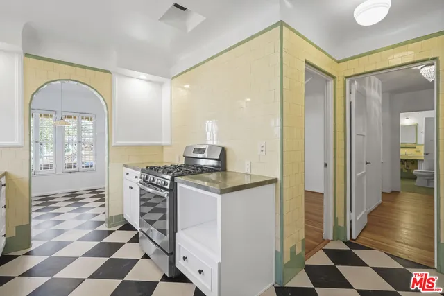 a kitchen with stainless steel appliances granite countertop a refrigerator and a stove top oven