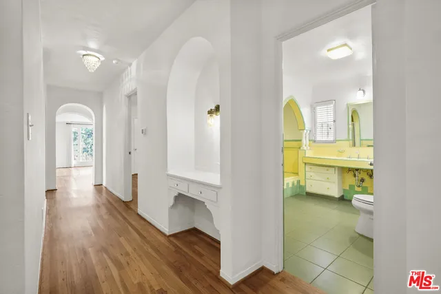 a bathroom with a sink mirror vanity and toilet
