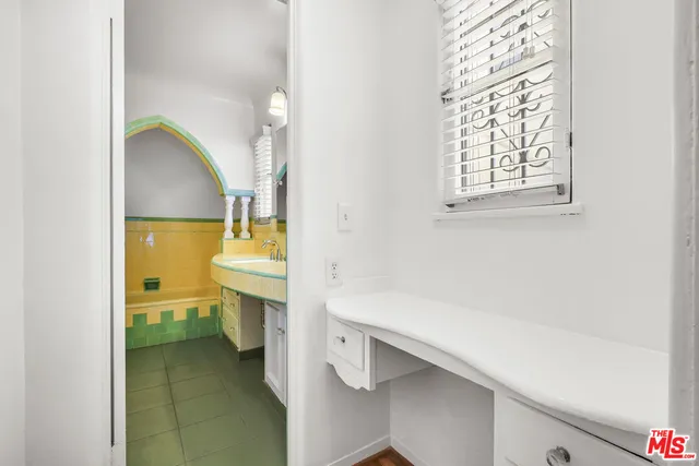 a view of empty room with wooden floor and window