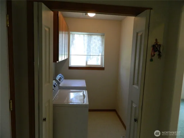 a bathroom with a light fixture a sink and a window