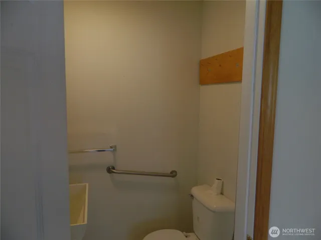 a white toilet sitting next to a shower