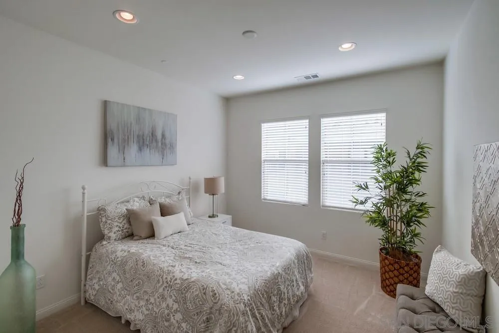 16629 Gill Loop San Diego, CA 92127 - Photo 18 of 25 a spacious bedroom with a bed and a potted plant