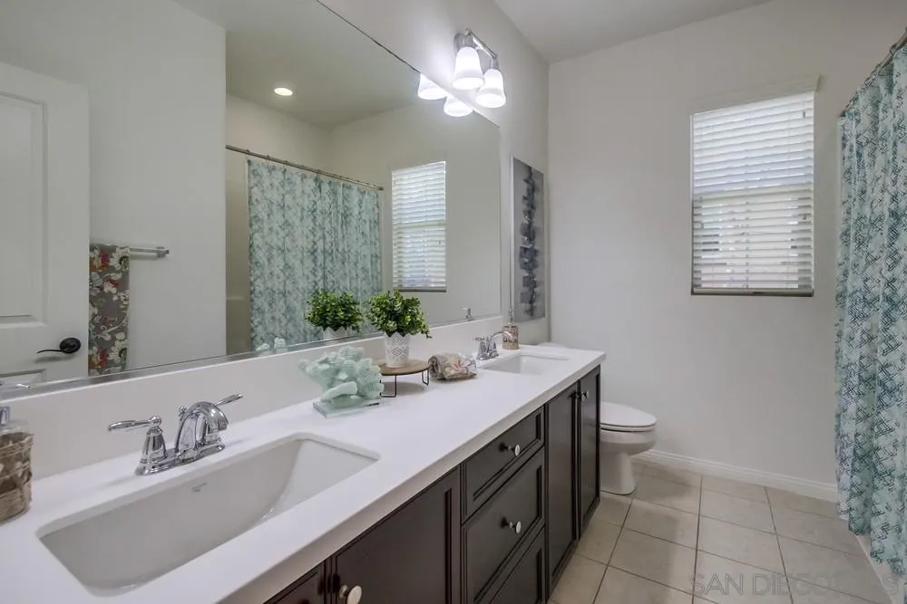 16629 Gill Loop San Diego, CA 92127 - Photo 20 of 25 a bathroom with a double vanity sink and a mirror