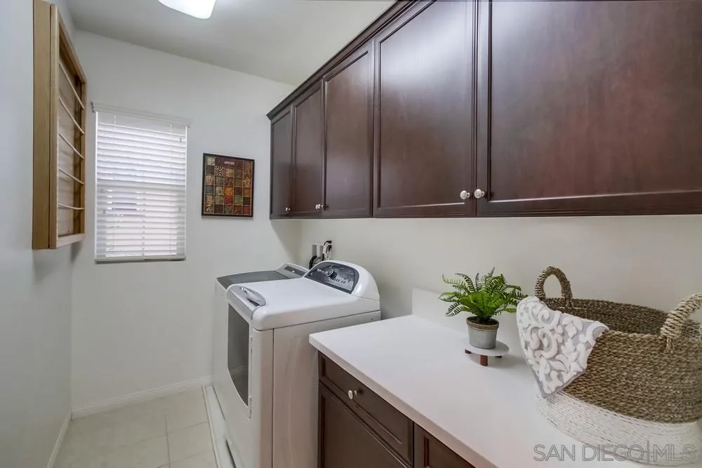 16629 Gill Loop San Diego, CA 92127 - Photo 21 of 25 a kitchen with a sink a microwave and cabinets