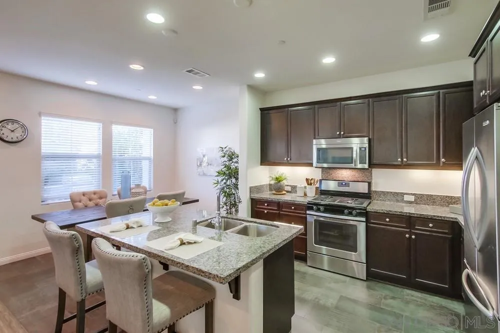 16629 Gill Loop San Diego, CA 92127 - Photo 7 of 25 a kitchen with a stove sink and microwave