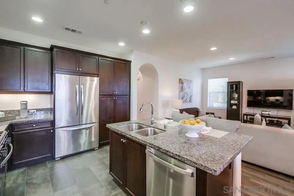 16629 Gill Loop San Diego, CA 92127 - Photo 9 of 25 a kitchen with stainless steel appliances granite countertop a sink refrigerator and microwave