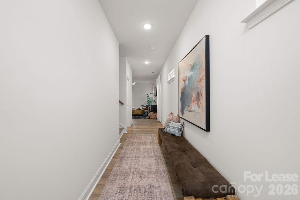 9100 Bluedale Road Charlotte, NC 28216 - Photo 18 of 48 a view of a hallway with wooden floor and staircase