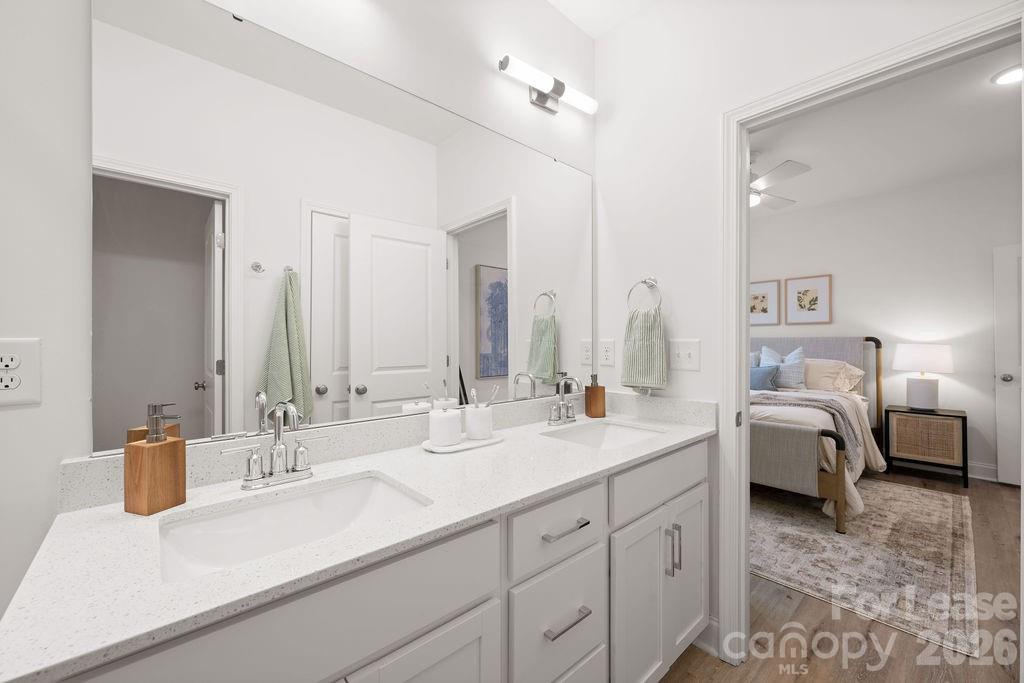9100 Bluedale Road Charlotte, NC 28216 - Photo 24 of 48 a en suite bathroom with a double vanity sink and a mirror