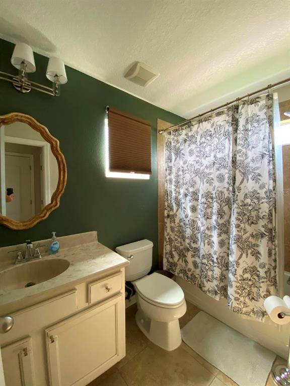 809 North Oregon Avenue Tampa, FL 33606 - Photo 12 of 16 a bathroom with a granite countertop toilet sink and mirror