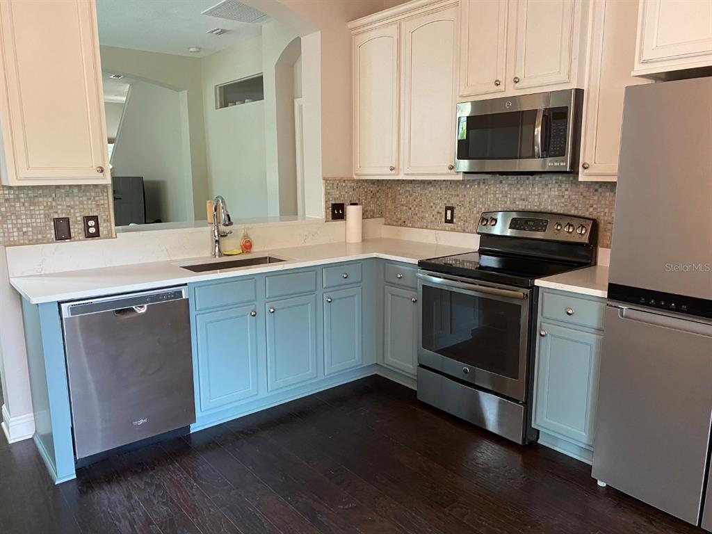 809 North Oregon Avenue Tampa, FL 33606 - Photo 5 of 16 a kitchen with stainless steel appliances granite countertop a stove a sink and a microwave