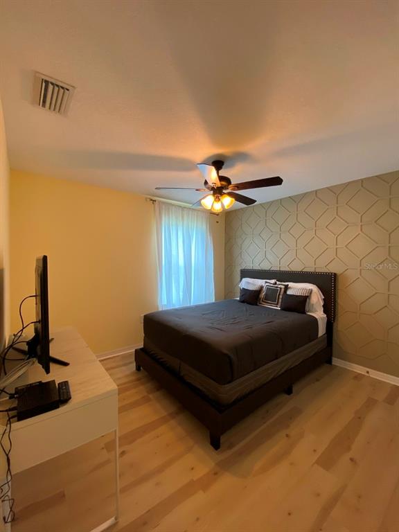 809 North Oregon Avenue Tampa, FL 33606 - Photo 9 of 16 a bedroom with a bed and a chandelier