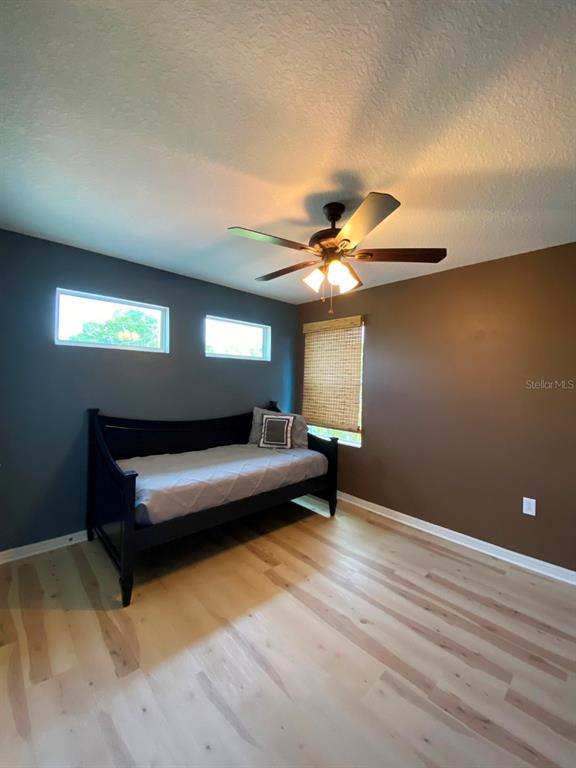 809 North Oregon Avenue Tampa, FL 33606 - Photo 10 of 16 a bedroom with a bed and a ceiling fan