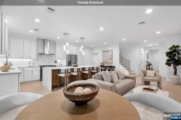 a living room with furniture and a view of kitchen