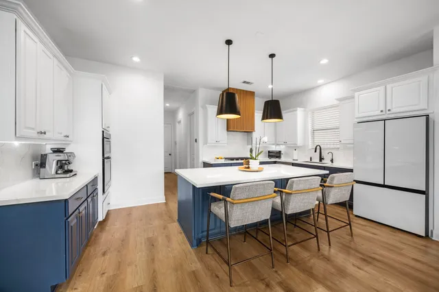 a kitchen with stainless steel appliances a stove a sink cabinets and a counter space