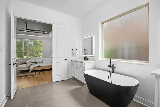 a bedroom with bed and a flat screen tv