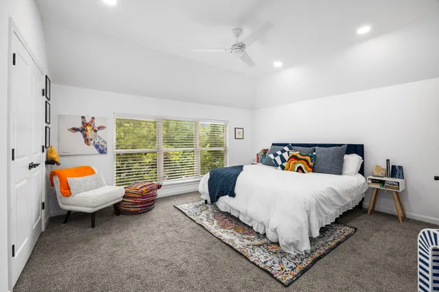 front view of a house with a big yard and large trees