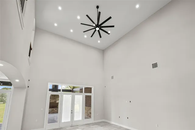 a view of a hallway with a ceiling fan