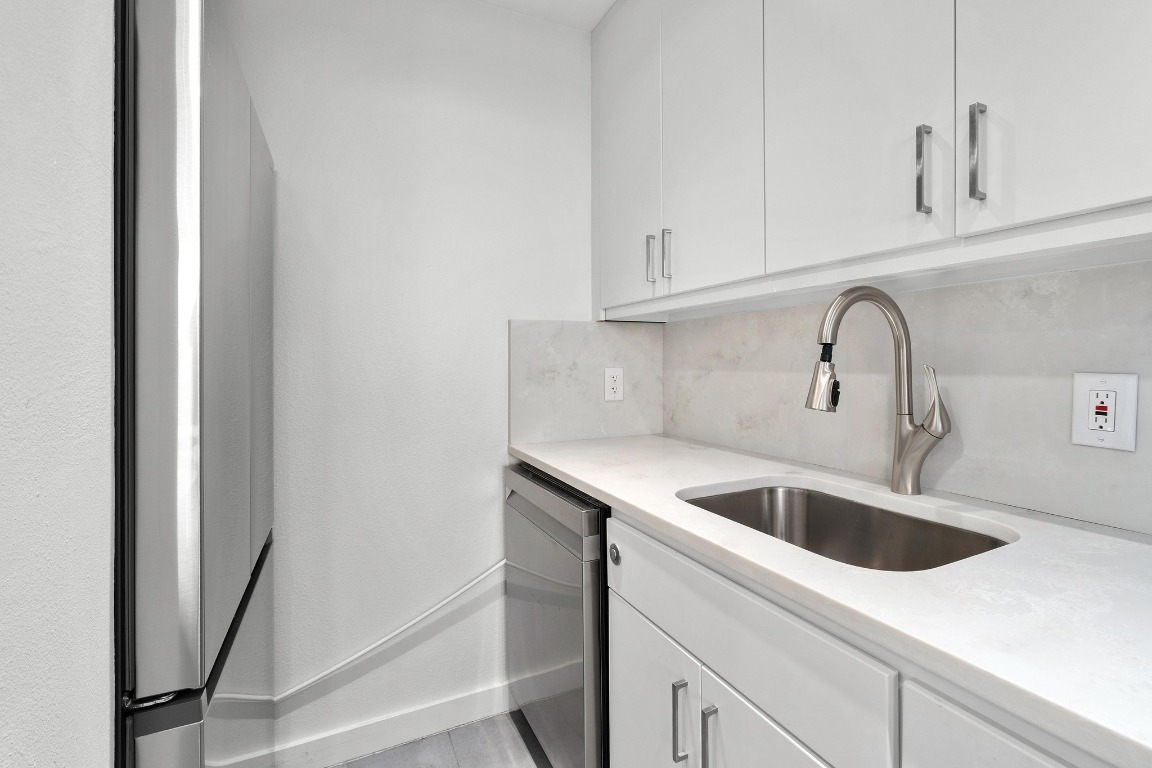 1801 Lavaca Street, Unit 7B Austin, TX 78701 - Photo 13 of 40 a kitchen with sink and cabinets