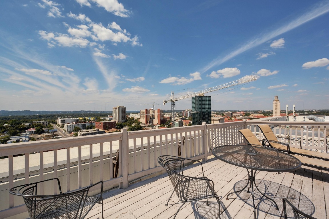 1801 Lavaca Street, Unit 7B Austin, TX 78701 - Photo 32 of 40 a view of a balcony with wooden chairs
