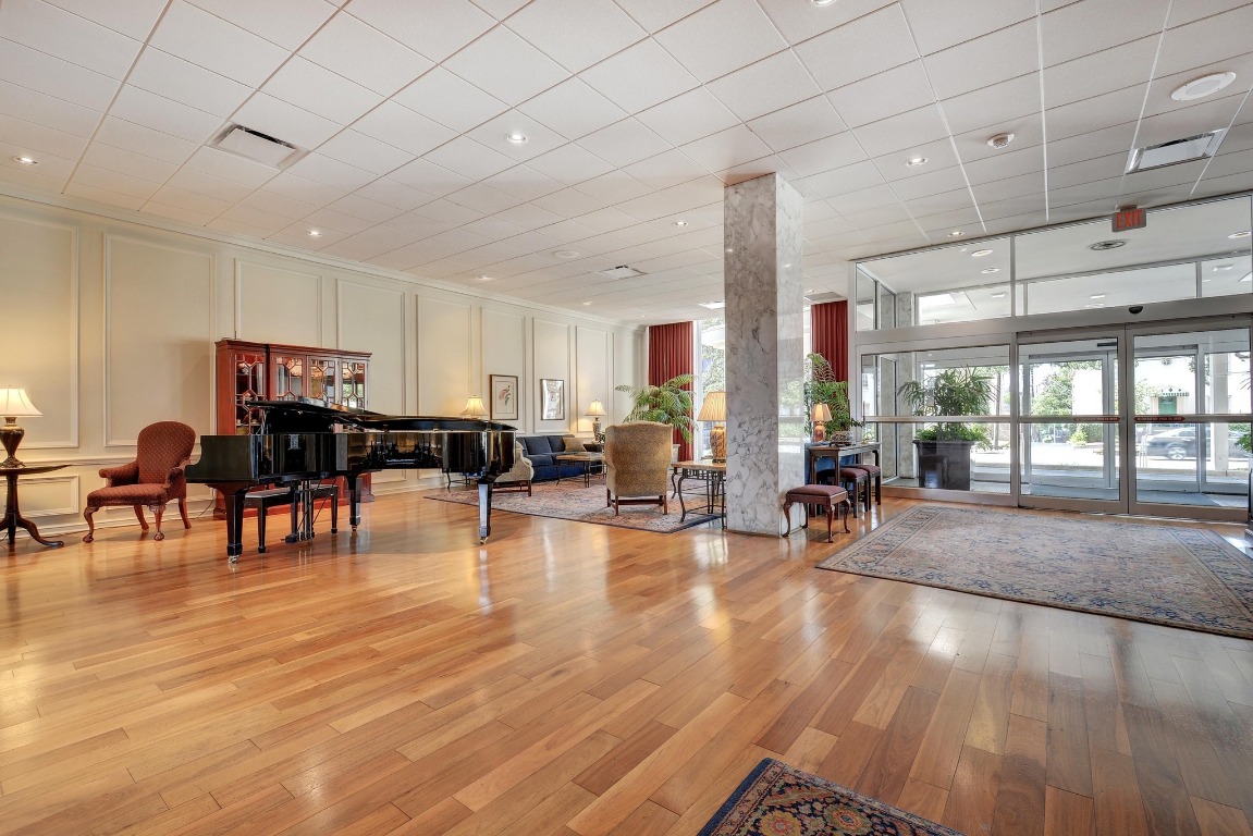 1801 Lavaca Street, Unit 7B Austin, TX 78701 - Photo 37 of 40 a living room with furniture and kitchen view with wooden floor