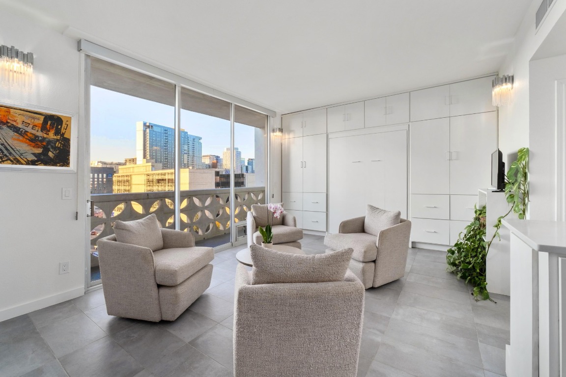 1801 Lavaca Street, Unit 7B Austin, TX 78701 - Photo 7 of 40 a living room with furniture and a large window