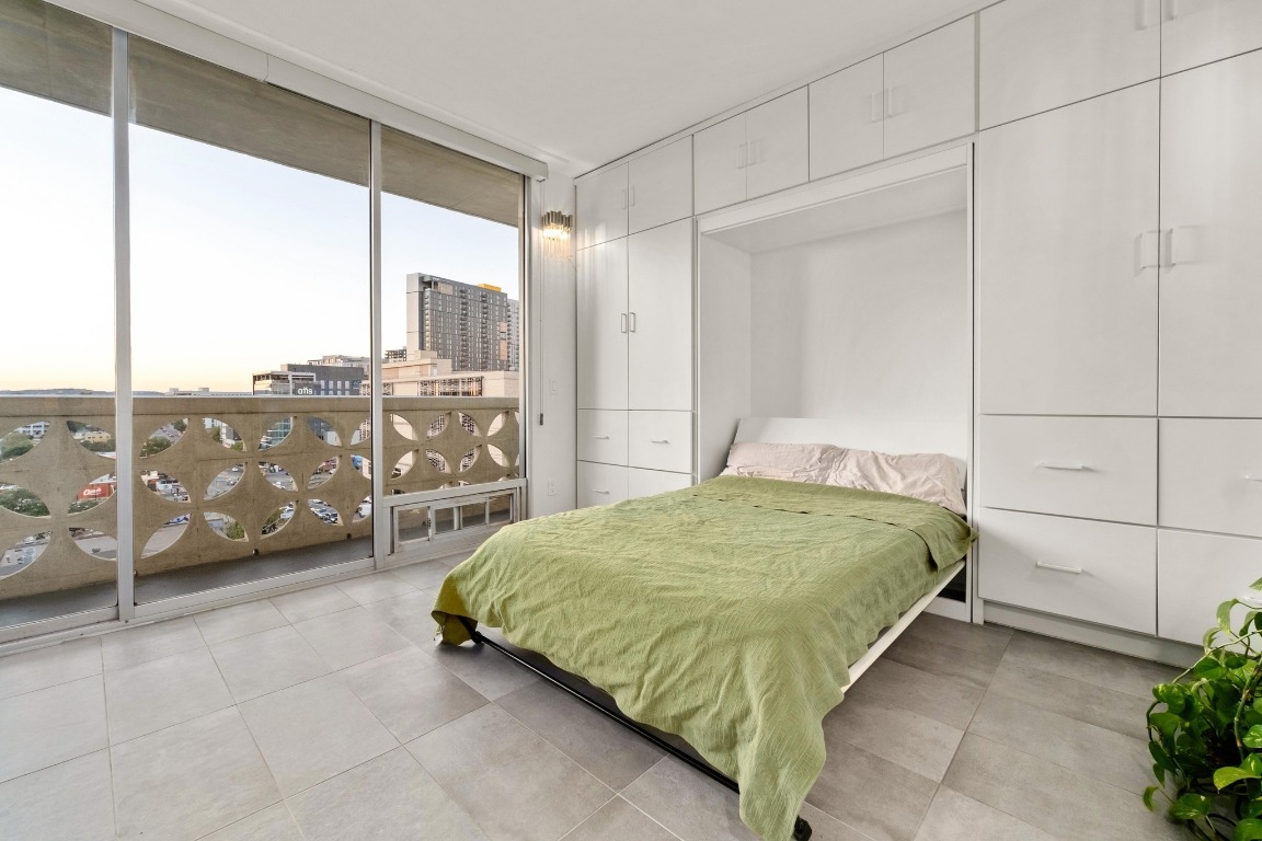 1801 Lavaca Street, Unit 7B Austin, TX 78701 - Photo 8 of 40 a bedroom with a bed and large window