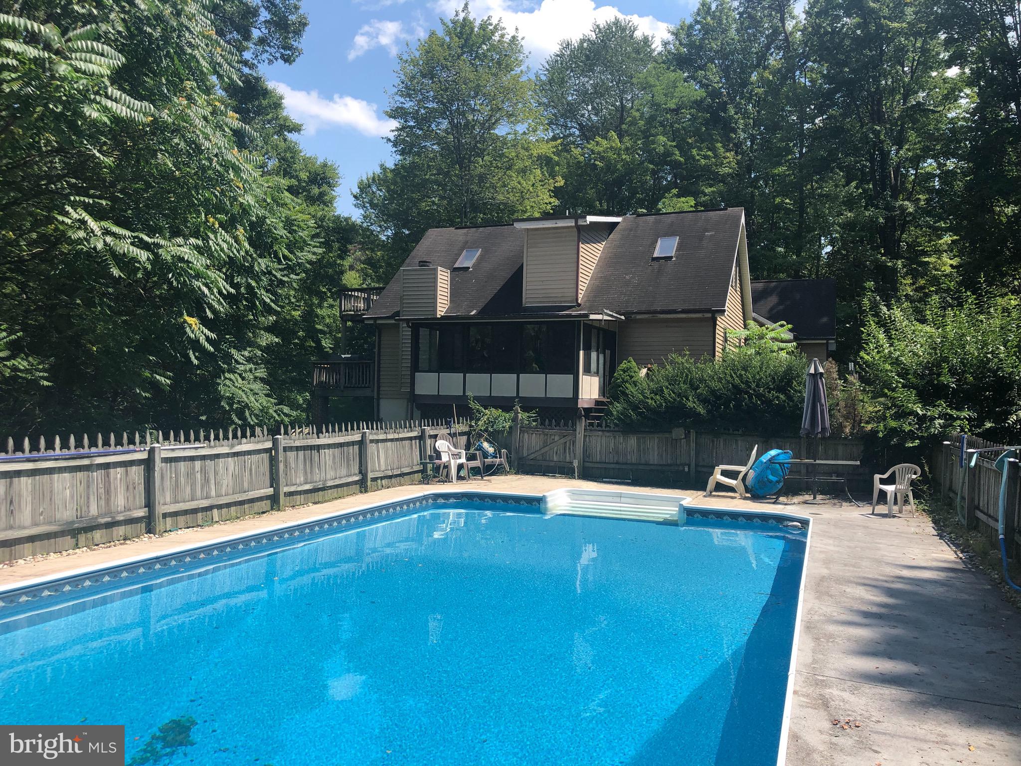 1260 County Rte 1/1 Berkeley Springs, WV 25411 - Photo 6 of 29 From pool looking at the side of home