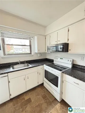 a kitchen with kitchen island cabinets and window