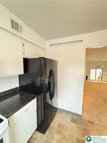 a view of a kitchen from the hallway