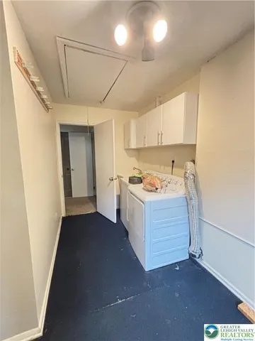 a view of staircase with white walls and white door