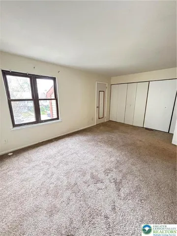a view of room with stairs and a door