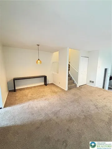 a kitchen with a refrigerator and a stove top oven