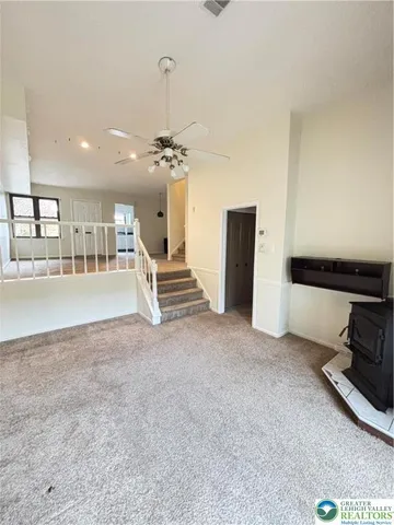 a kitchen with stainless steel appliances a refrigerator stove and white cabinets