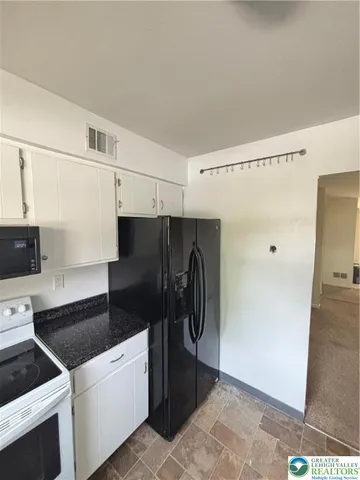 a kitchen with stainless steel appliances granite countertop a sink and cabinets