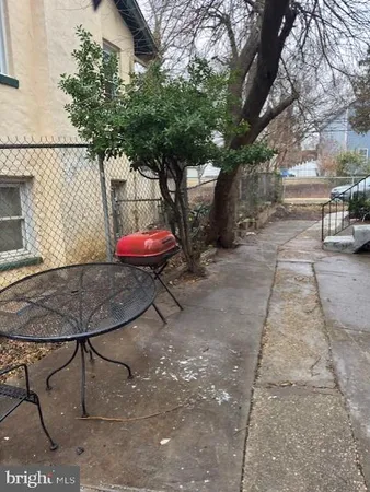 a view of a backyard with table and chairs under an umbrella