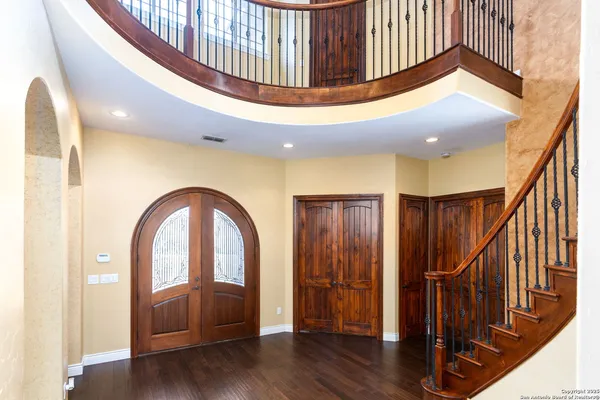 a view of entryway with wooden floor and stairs