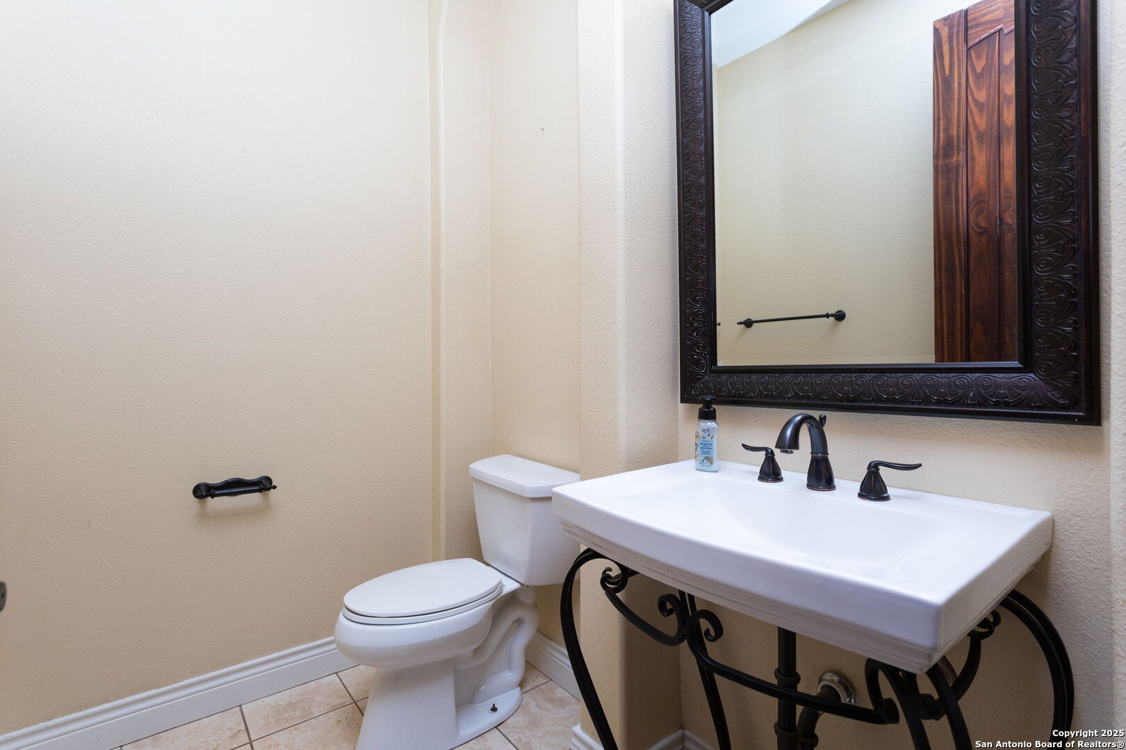 192 County Road 2812 Mico, TX 78056 - Photo 19 of 47 a bathroom with a toilet a sink and mirror