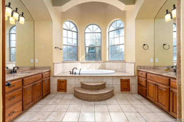 a bathroom with a double vanity sink and a mirror