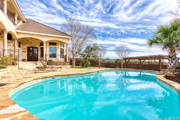 a swimming pool with outdoor seating and yard