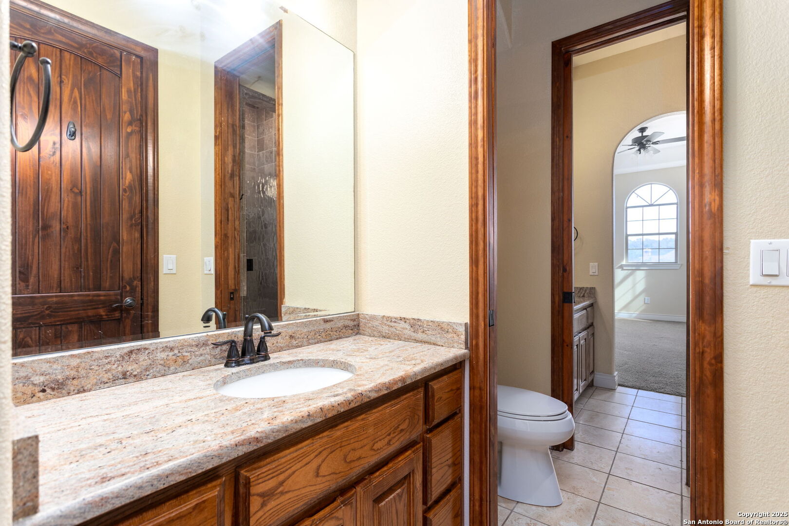 192 County Road 2812 Mico, TX 78056 - Photo 37 of 47 a bathroom with a granite countertop sink and a mirror