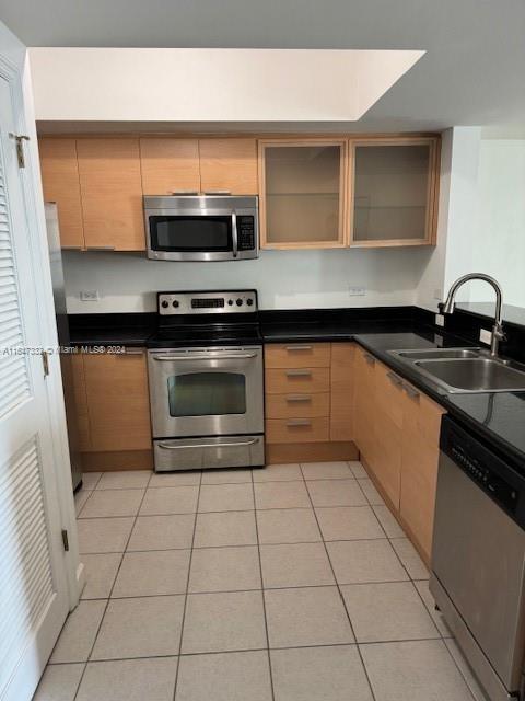 a kitchen with stainless steel appliances a sink dishwasher stove and microwave