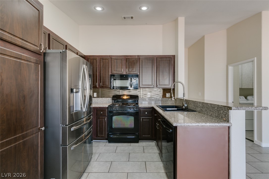 2028 Rustler Ridge Avenue North Las Vegas, NV 89031 - Photo 21 of 40 Granite counters and stainless steel appliances complete this well-appointed kitchen.