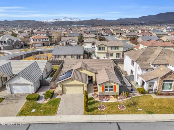 an aerial view of residential houses with outdoor space and parking