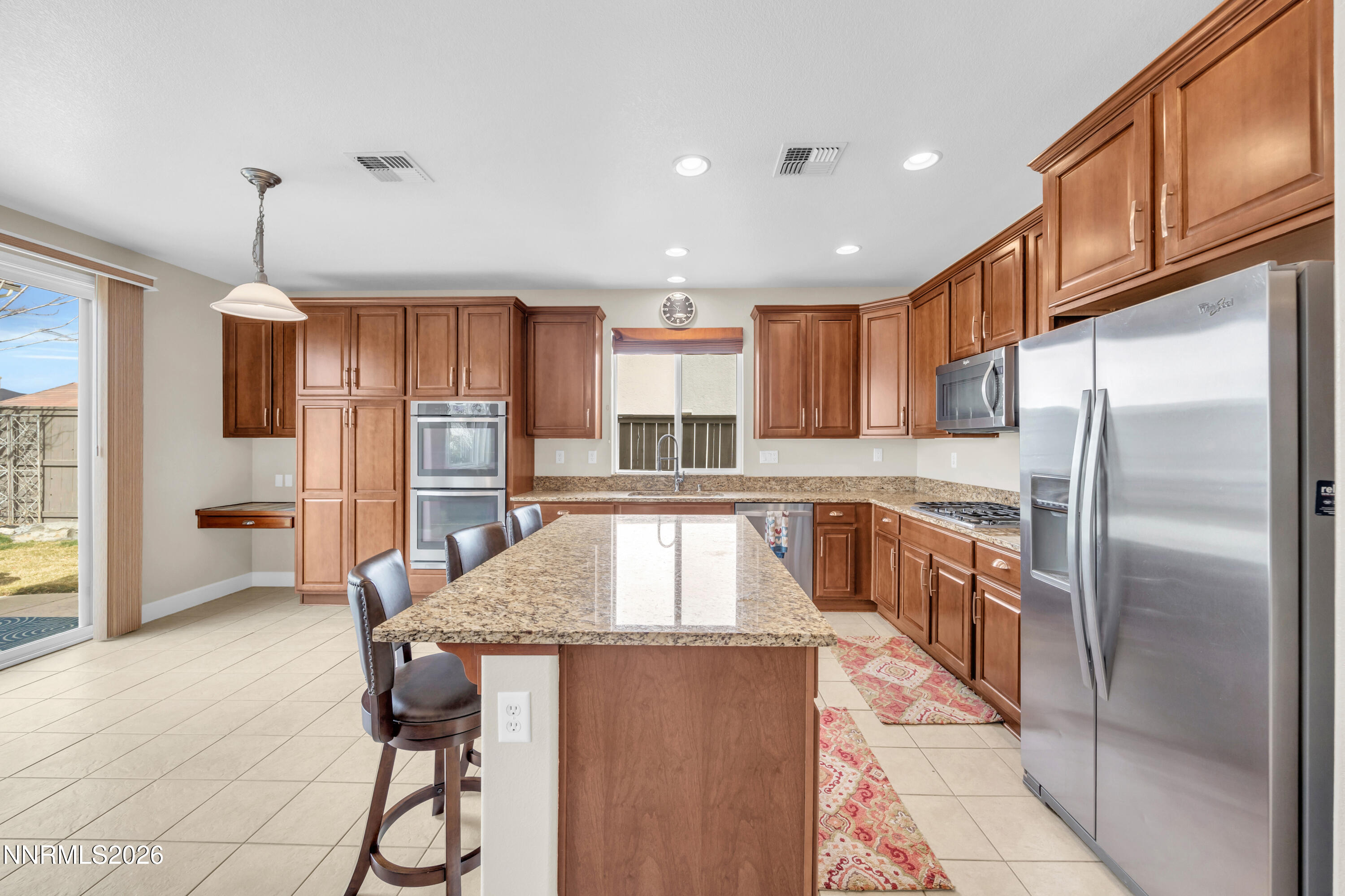 7119 Coldwater Street Sparks, NV 89436 - Photo 25 of 45 a kitchen with stainless steel appliances granite countertop a refrigerator a sink and a stove